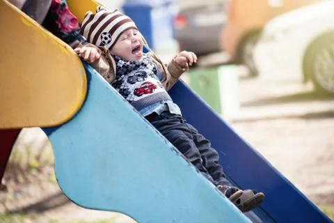 The child rolls down the hill Stock Photos