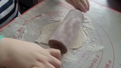 Child rolls out dough Stock Footage 317830464