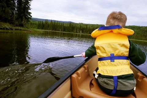 Child Rows A Canoe Stock Photos