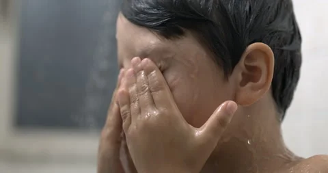 Child rubbing eyes during bath time in super slow-motion, close-up kid face.. Stock Footage 250220079