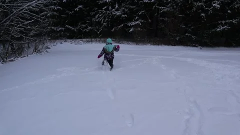 Child Running and Falling in Winter Clothes White Snow with Trees RT Motion Video stock 145875585