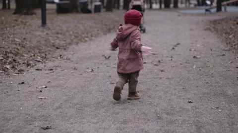Child running away along the path in the park Stock Footage 152302990