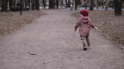 Child running away along the path in the park Stock Footage 152303024