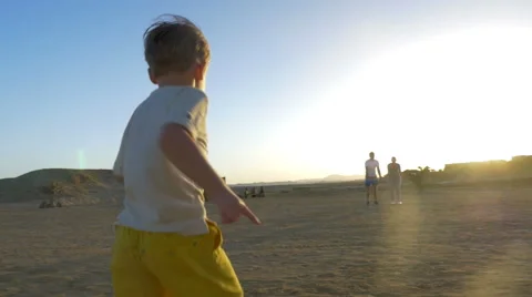 Child running to beloved mom and dad Stock Footage