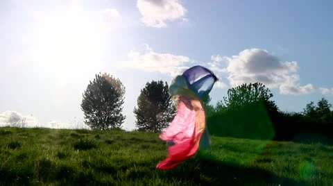 Child running with a rainbow silk Stock Footage 22637553