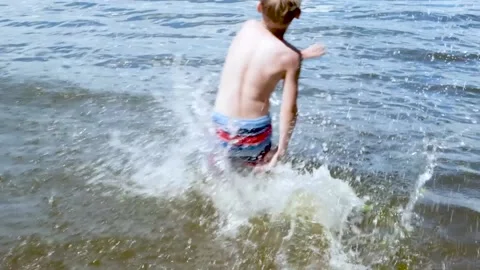 A child running into the river. Slow motion. Stock Footage 202717618
