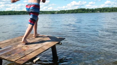 A child running into the river. Slow motion Stock Footage 202717620