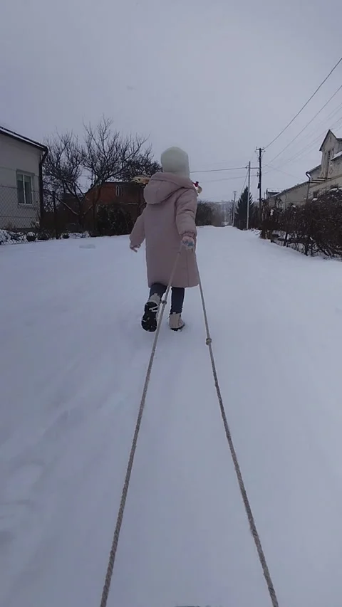 Child running with a sled Stock-Footage 318946127