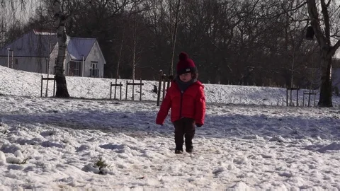 Child running in the snow Stock Footage 102388691