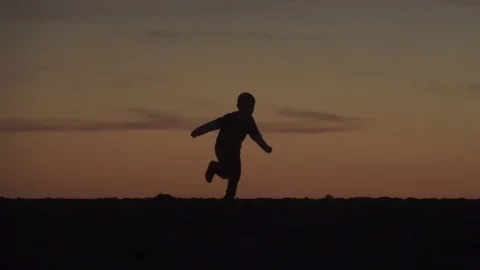 Child Running at Sunset Silhouette Video stock 80323709
