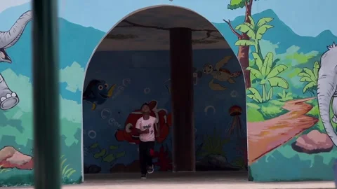 Child Running Through Cartoon-Themed Tunnel at Playground in Dibrugarh 스톡 동영상 334774248
