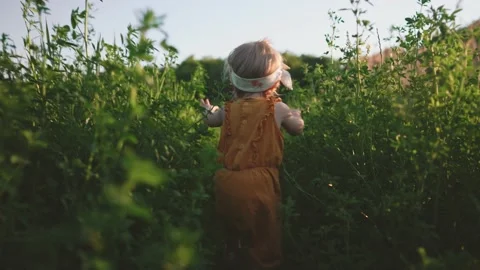 Child running through the grass to mothe... | Stock Video | Pond5