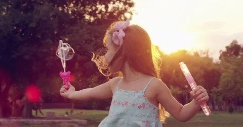Child Running Through Park With Soap Bubbles Little Girl Childhood Fun Carefree Stock Footage