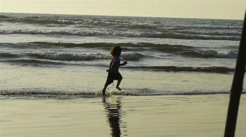 Child runs at a beach Stock Footage 10792088