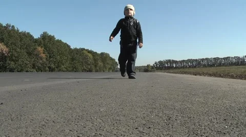 Child runs on the road Stock Footage 954732