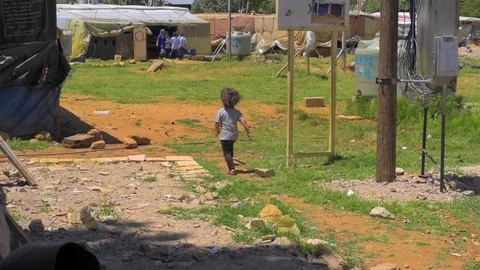 Child runs through Refugee Camp Video stock 79043155