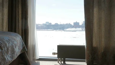 The child runs to the window. The kid knocks on the window. Girl looking out the Stock Footage 76086914