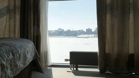 The child runs to the window. The kid knocks on the window. Girl looking out the Stock Footage 76087058