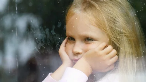 The child is sad at the dirty window Stock Footage 116044886