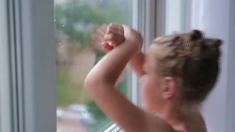 The child is sad at the window. Stock Footage 161869198