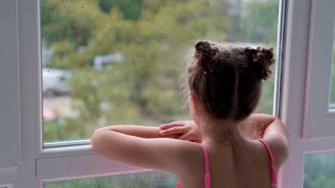 The child is sad at the window. Stock Footage 161869277