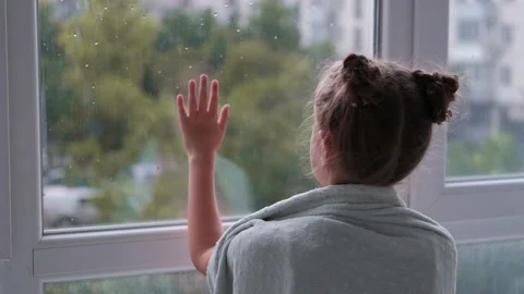 The child is sad at the window. Stock Footage 161869495
