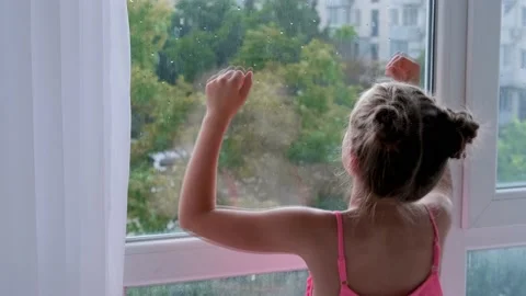 The child is sad at the window. Stock Footage 161869677