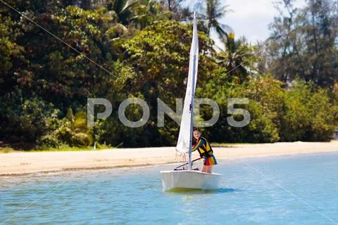 Child sailing. Kid learning to sail on sea yacht. Stock Photos