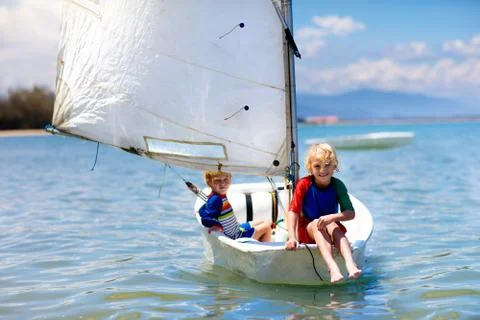 Child sailing. Kid learning to sail on sea yacht. Stock Photos