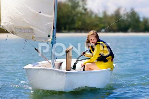 Child sailing. Kid learning to sail on sea yacht. Stock Photos