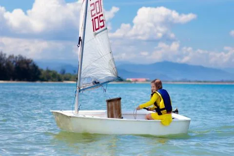 Child sailing. Kid learning to sail on sea yacht. Stock Photos