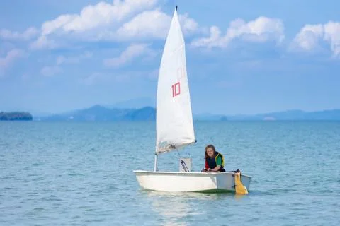 Child sailing. Kid learning to sail on sea yacht. Stock-Fotos