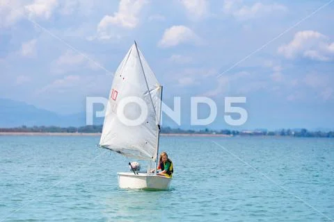 Child sailing. Kid learning to sail on sea yacht. Stock Photos