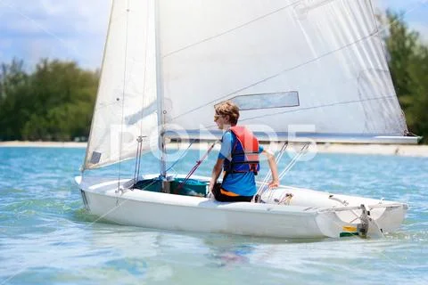 Child sailing. Kid learning to sail on sea yacht. Stock Photos