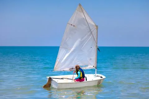 Child sailing. Kid learning to sail on sea yacht. Stock-Fotos