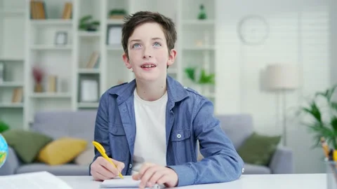 A Child school boy, a schoolboy talks while answering questions in an online  Stock Footage 238632740