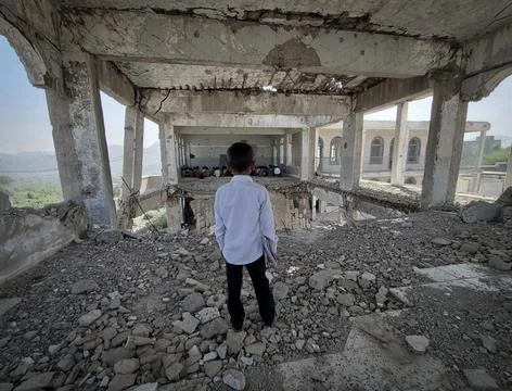 A child in a school destroyed by the war Stock Photos