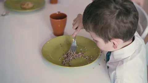 Child in school uniforms, breakfasts before going to school Stock Footage 105096939