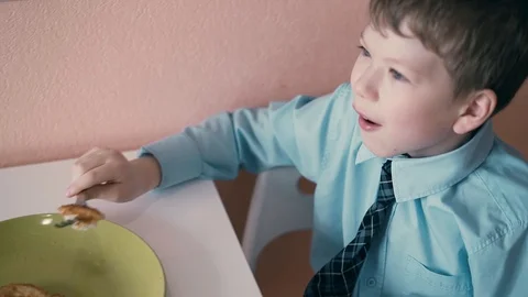 Child in school uniforms, breakfasts before going to school Stock Footage 105097133