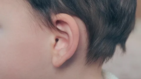 A child is scratching his ear, ear pain and inflammation in infants, Video stock 121112397