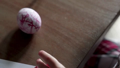 Child scribbling with red marker close up drawing on eggs. Stock Footage 332082337