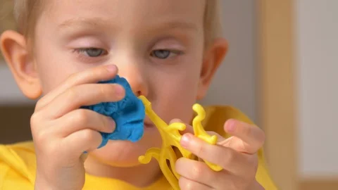Child is sculpting with modeling clay Stock-Footage 128091395