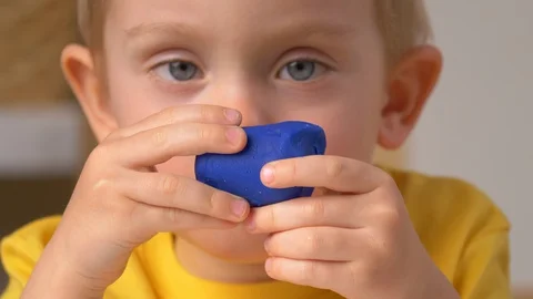 Child is sculpting with modeling clay Stock Footage 128177617