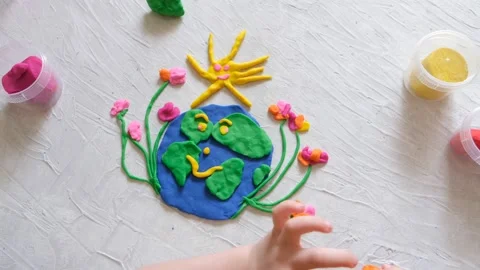 Child sculpturing plasticine planet for earth day. Protection of environment, Stock Footage 170910450