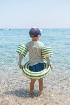 Child in Sea with Float Fotos Stock