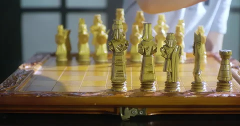 The child setting up chess board with handmade chess pieces. Stock Footage 149138580