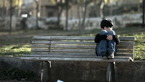 A Child Setting in Park With Sad Look Stock Footage