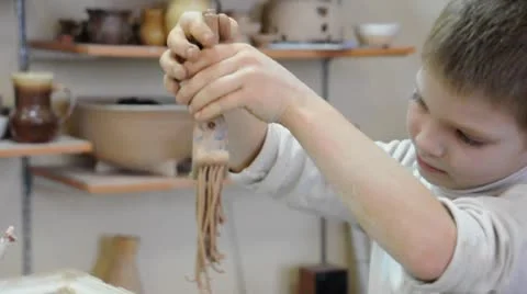 Child shaping with clay in pottery studio. Part 1. Stock Footage