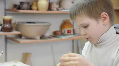 Child shaping with clay in pottery studio. Part 1. Stock Footage 10785548