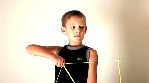 Child shooting a toy bow and arrow Stock Footage